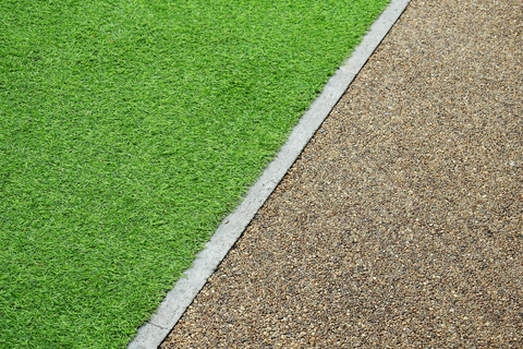 this paved walkway in Palm Springs CA is surrounded by artificial turf